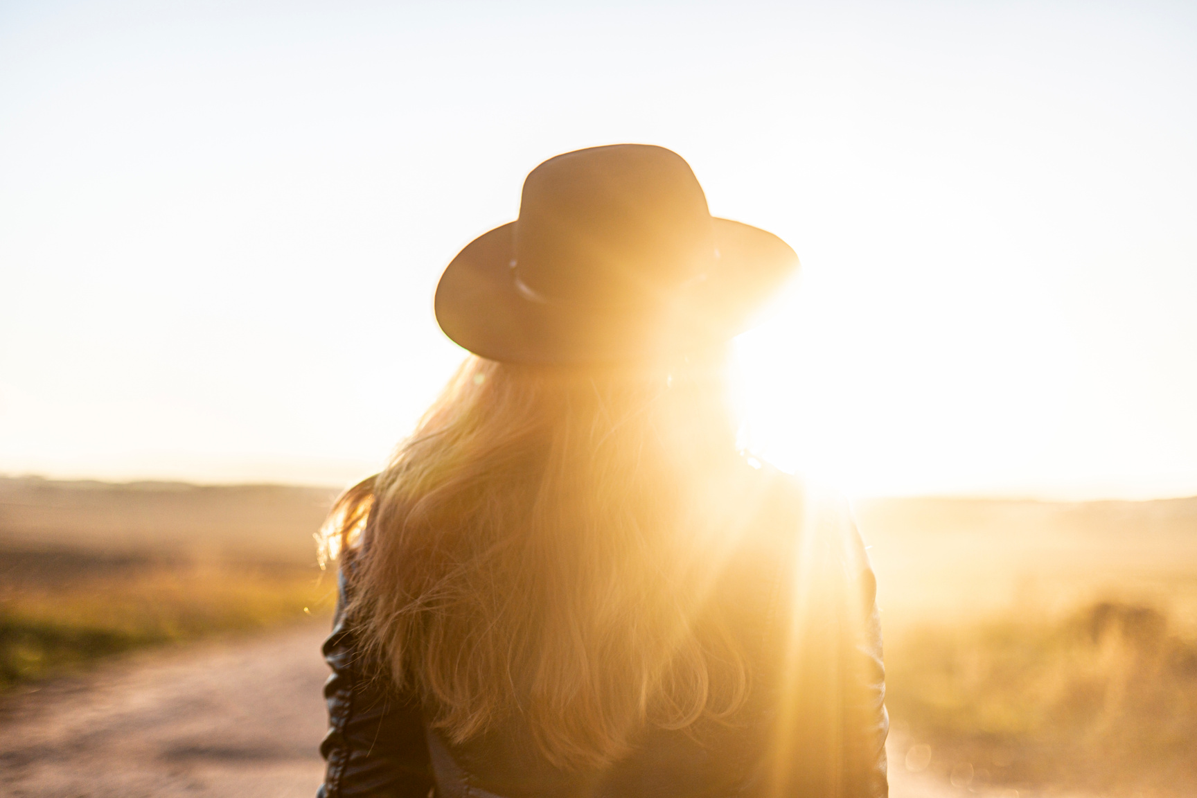 Back View of a Girl with Hat in Sunny Light